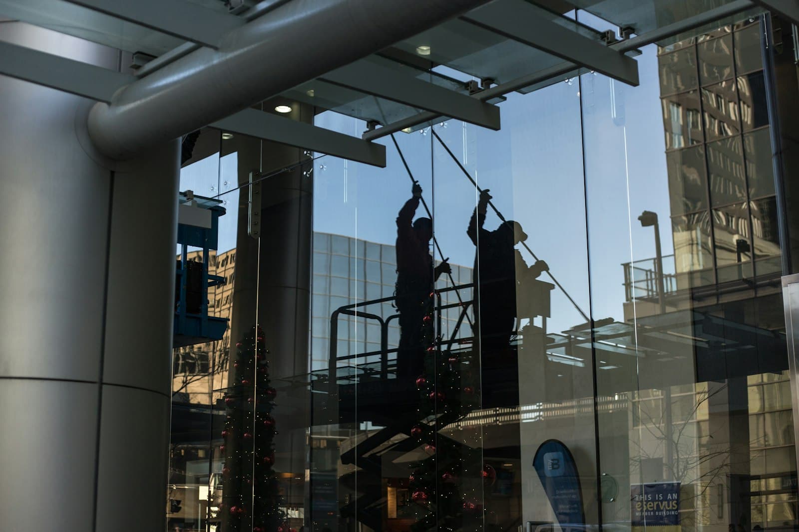 Window cleaners working on a commercial glass facade